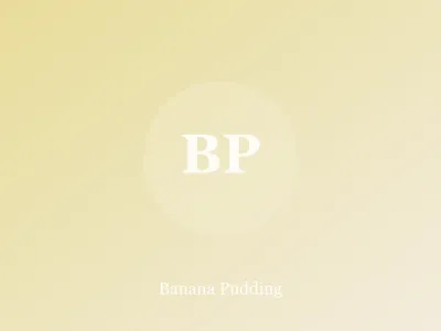 Glass dish of banana pudding with layers of custard, banana slices and vanilla wafers