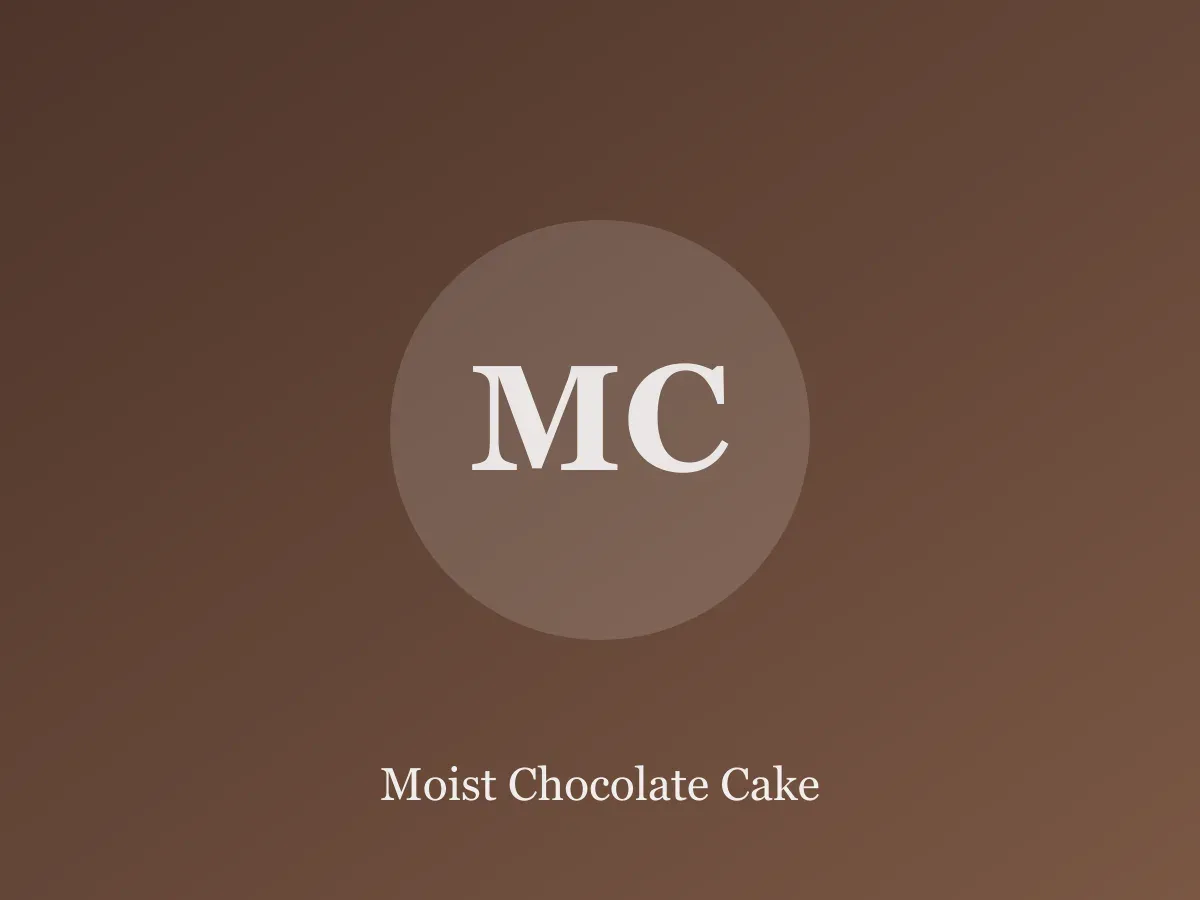 Slice of dark chocolate layer cake with glossy chocolate frosting on a cream plate