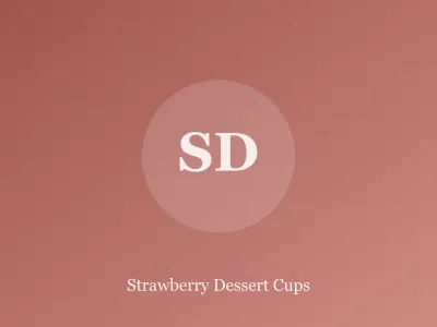 Glass cups layered with strawberries, whipped cream and cookie crumbs